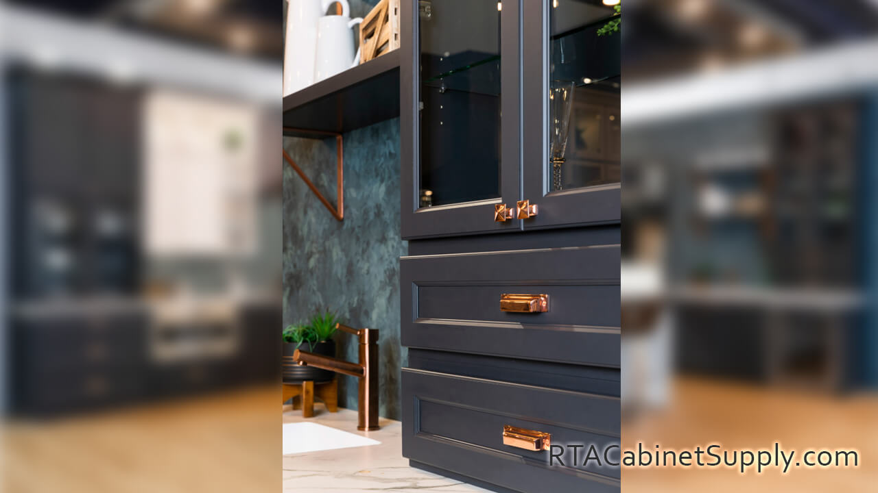 Hanover Charcoal kitchen close up view with wall cabinets and a glass door cabinet.