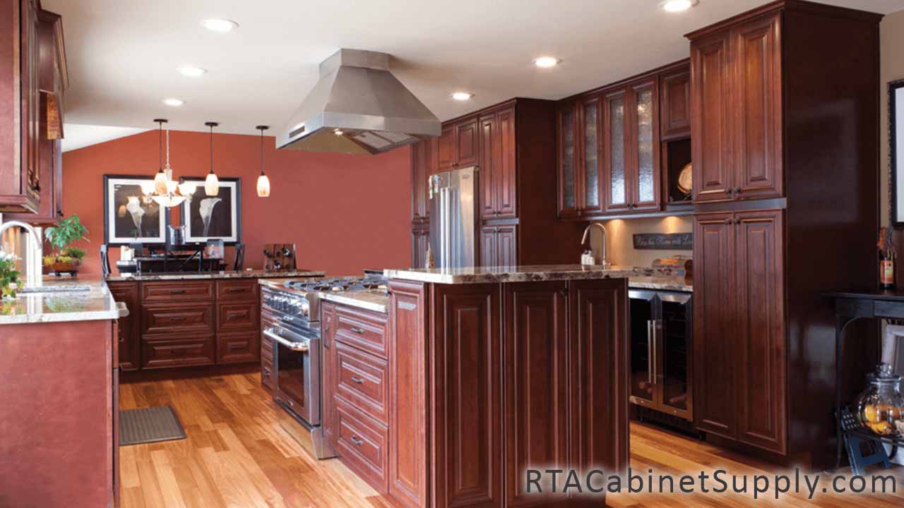Milan Sangria kitchen angle view with an island, a range hood, wall and base cabinets.