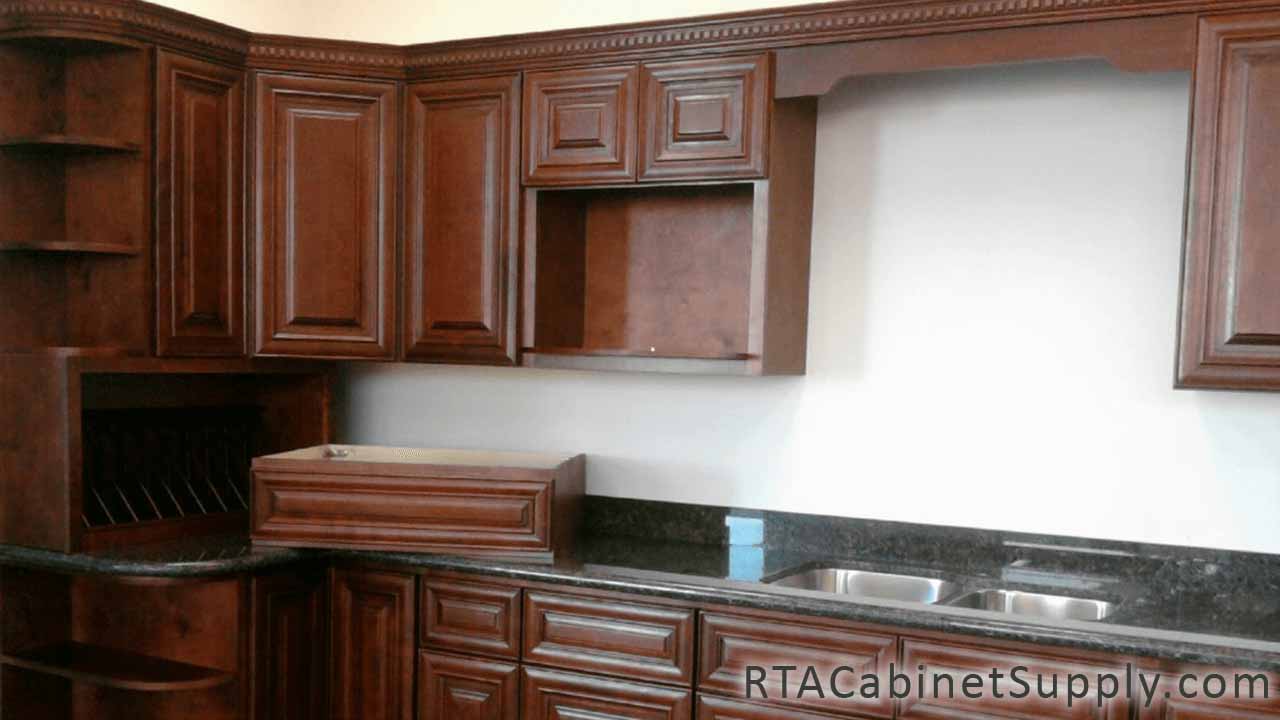 Milan Sangria kitchen close up angle view with wall and base cabinets and two sinks.