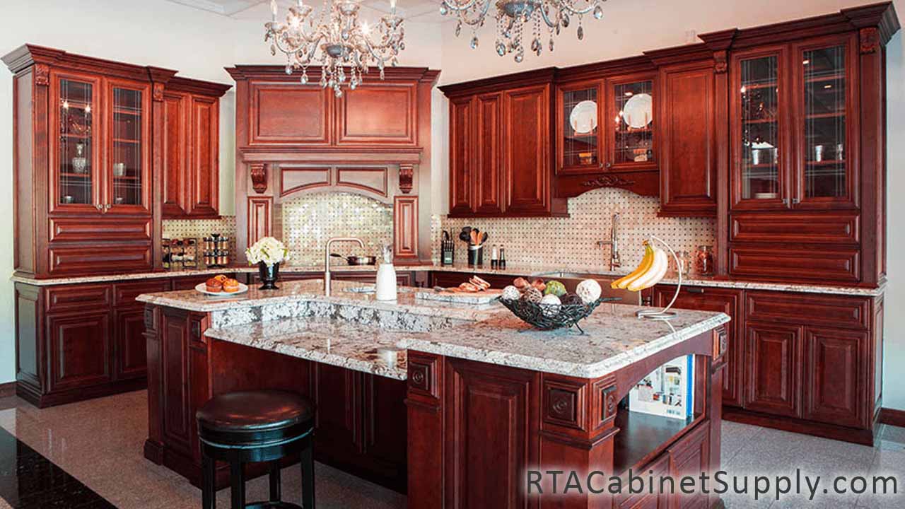 Milan Sangria kitchen angle view with an island, glass door cabinets, wall and base cabinets.