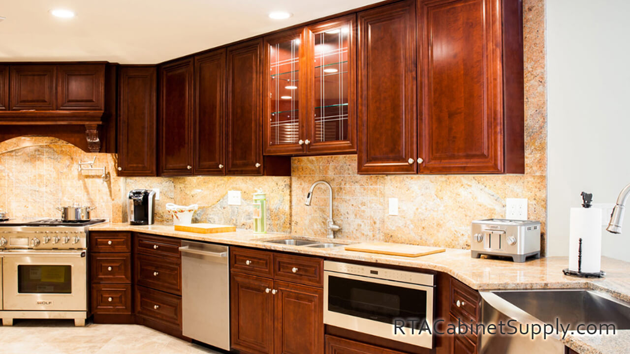 Milan Sangria kitchen angle view with a countertop, glass door cabinets, an oven and a kitchen sink.