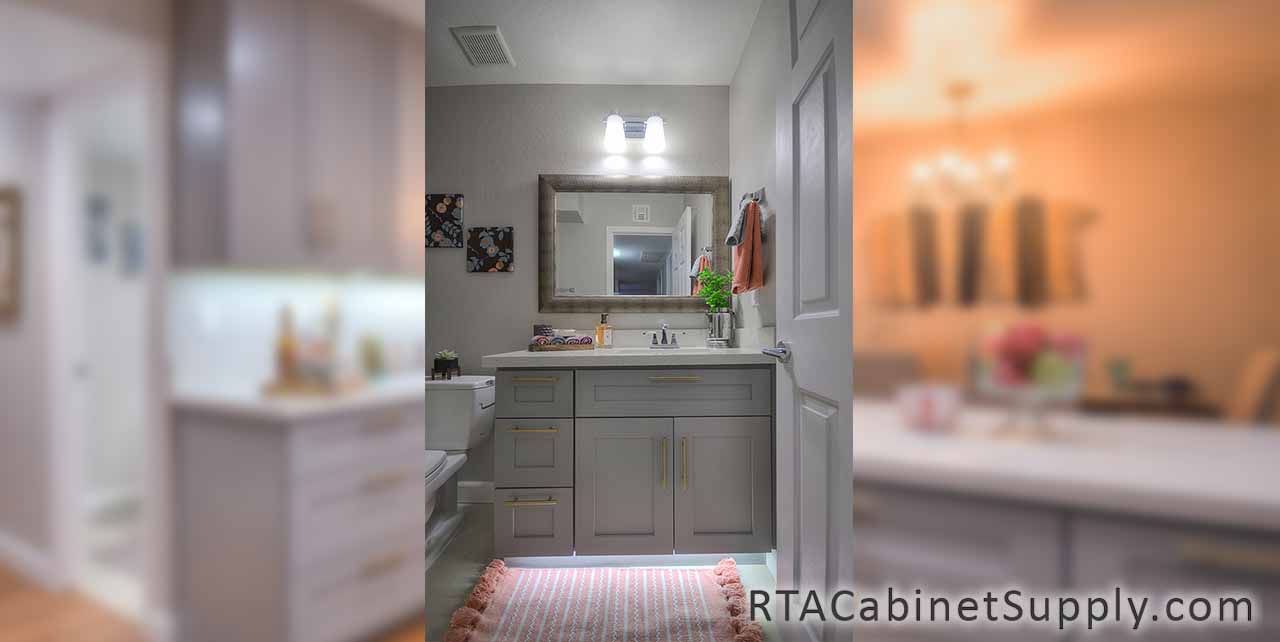Classic Grey Shaker bathroom close up view with base cabinets, a mirror and lighting.