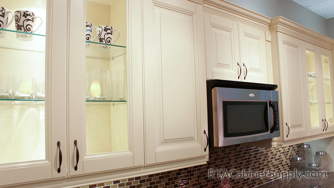 Holmdel Cream kitchen close up view with wall cabinets and glass door cabinets.