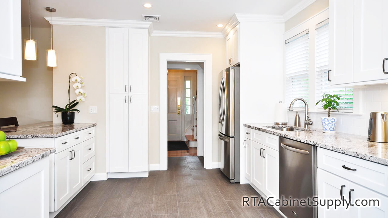 Newport White Shaker kitchen full view with a countertop, a fridge, lighting, wall and base cabinets.