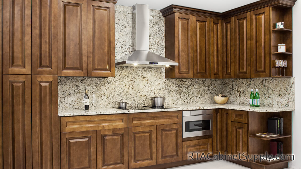 Nutmeg Modern kitchen close up view with open shelving, a range hood, a countertop, pantry cabinets, wall and base cabinets.