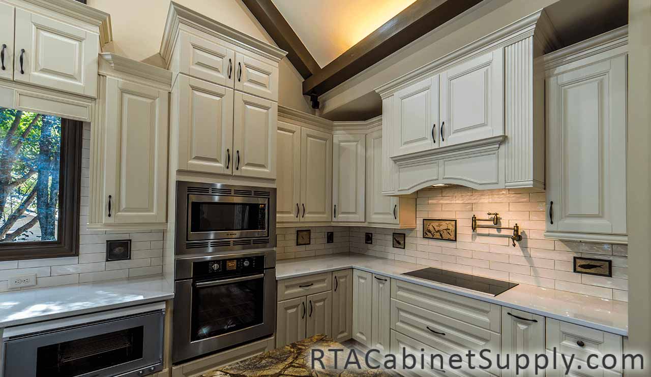 Oxfrord Cream kitchen angle view with a countertop, an oven, wall and base cabinets.