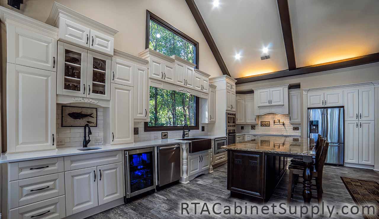 Oxfrord Cream kitchen full angle view with a countertop, an island, a fridge, lighting, a glass door cabinet, wall and base cabinets.