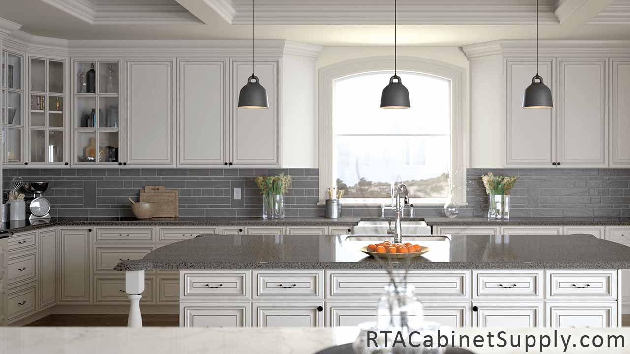 Pearl Glaze kitchen full view with an island, lighting, glass door cabinets, wall and base cabinets.