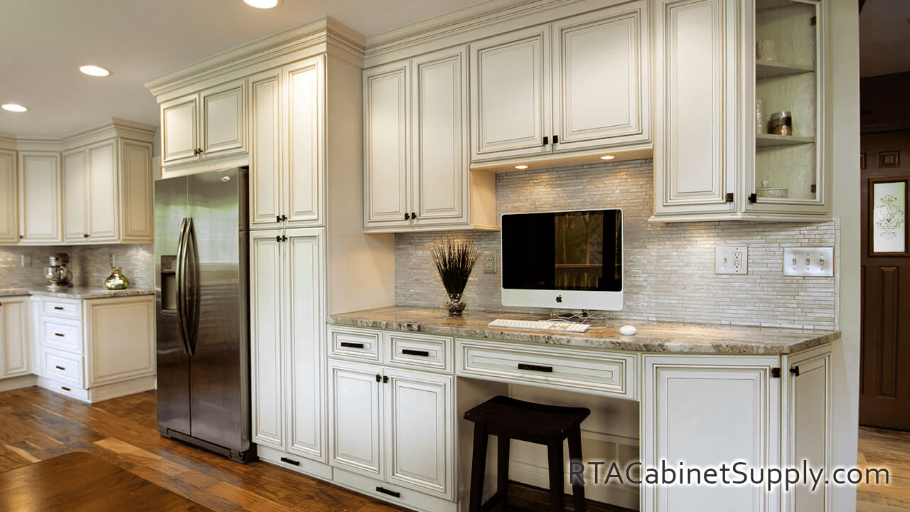 Pearl Glaze kitchen angle view with a fridge, a glass door cabinet, a countertop, a pantry cabinet, wall and base cabinets.