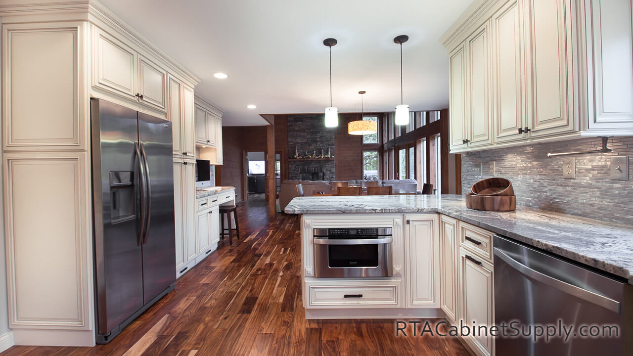 Pearl Glaze kitchen full view with a fridge, an oven, lighting, a countertop, a pantry cabinet, wall and base cabinets.