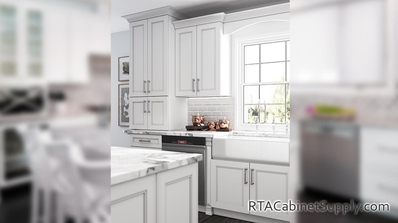 Preston White kitchen close up angle view with an island, a farmhouse sink cabinet, wall and base cabinets.