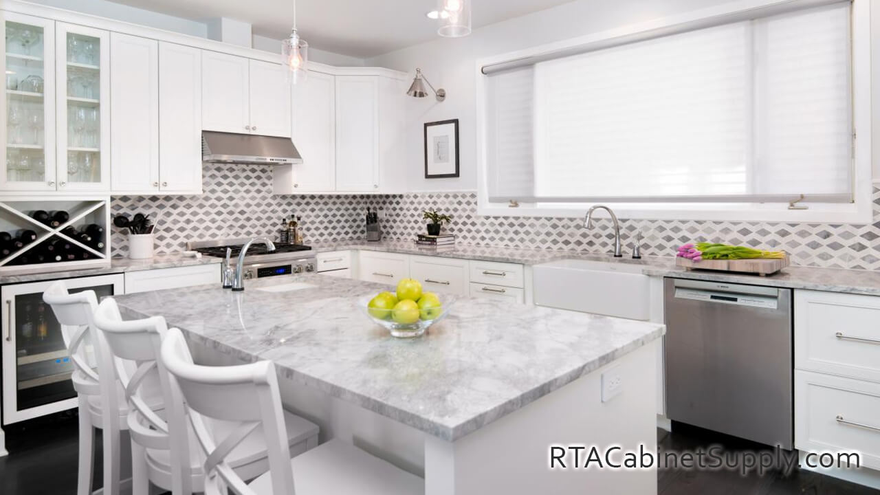 Preston White kitchen full angle view with an island, a range hood, a countertop, glass door cabinets, wall and base cabinets.