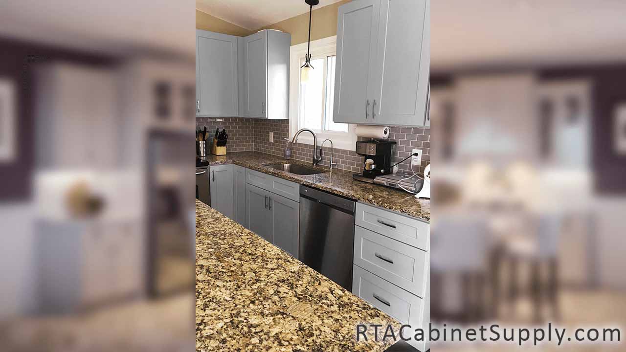Salem Dove Shaker kitchen angle view with a countertop, wall and base cabinets.