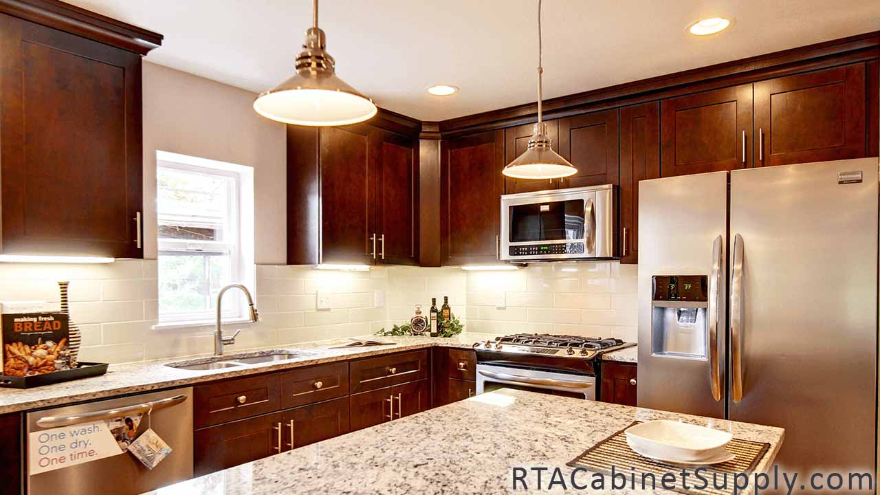 Sienna Shaker kitchen angle view with a fridge, a countertop, lighting, wall and base cabinets.