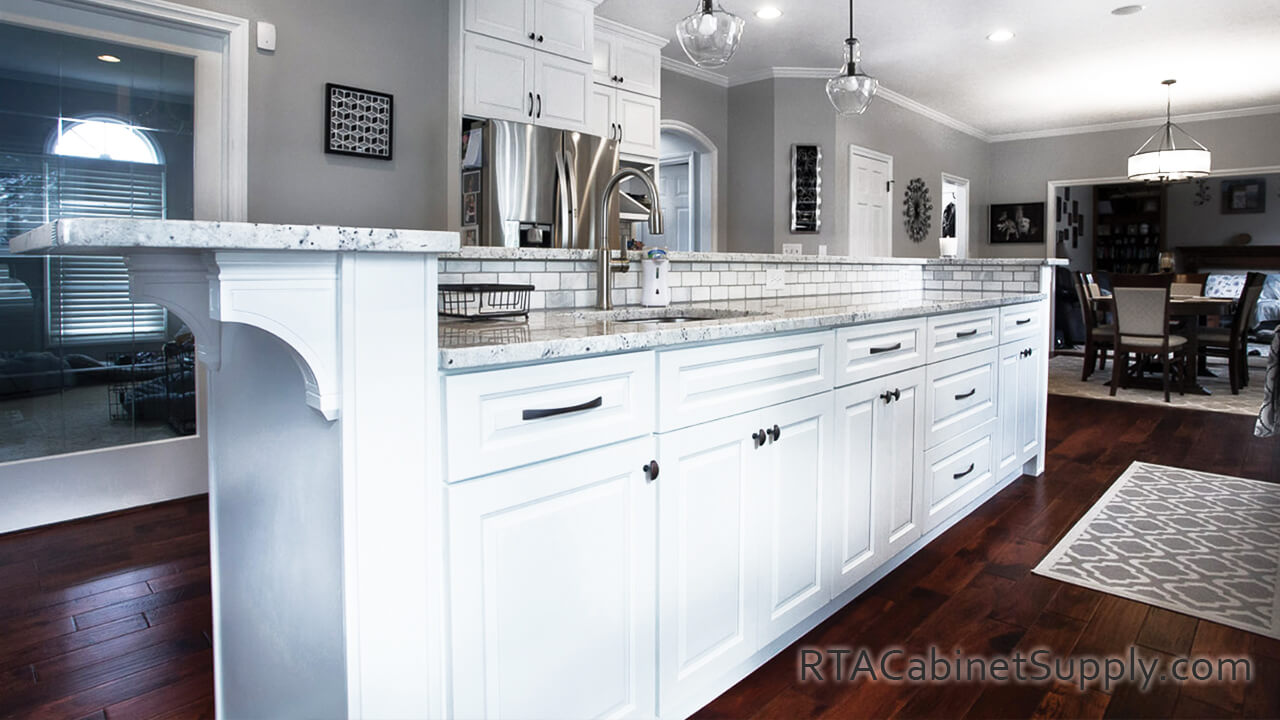 Verona White kitchen angle view with lighting and base cabinets.