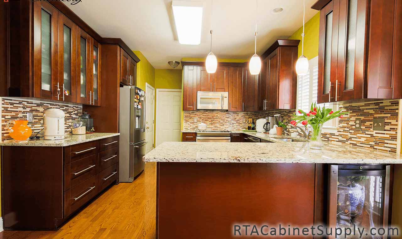 Walnut Shaker kitchen full view with an oven, glass door cabinets, a countertop, lighting, wall and base cabinets.