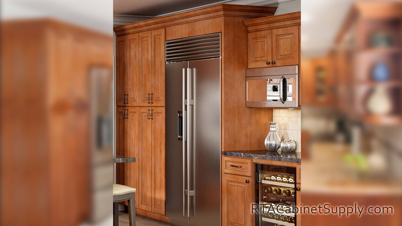 Windsor Cinnamon Glaze kitchen close up view with pantry cabinets, a fridge, wall and base cabinets.