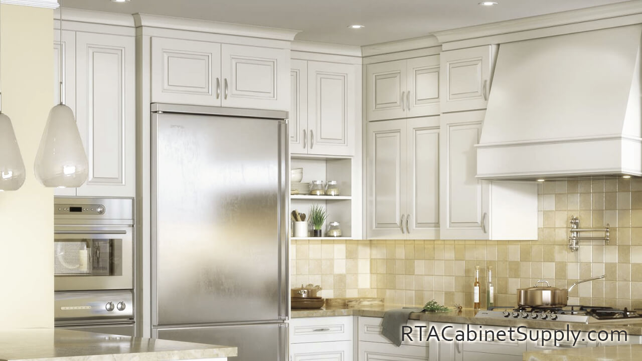Windsor Ivory kitchen close up view with a countertop, a range hood cover, wall and base cabinets.