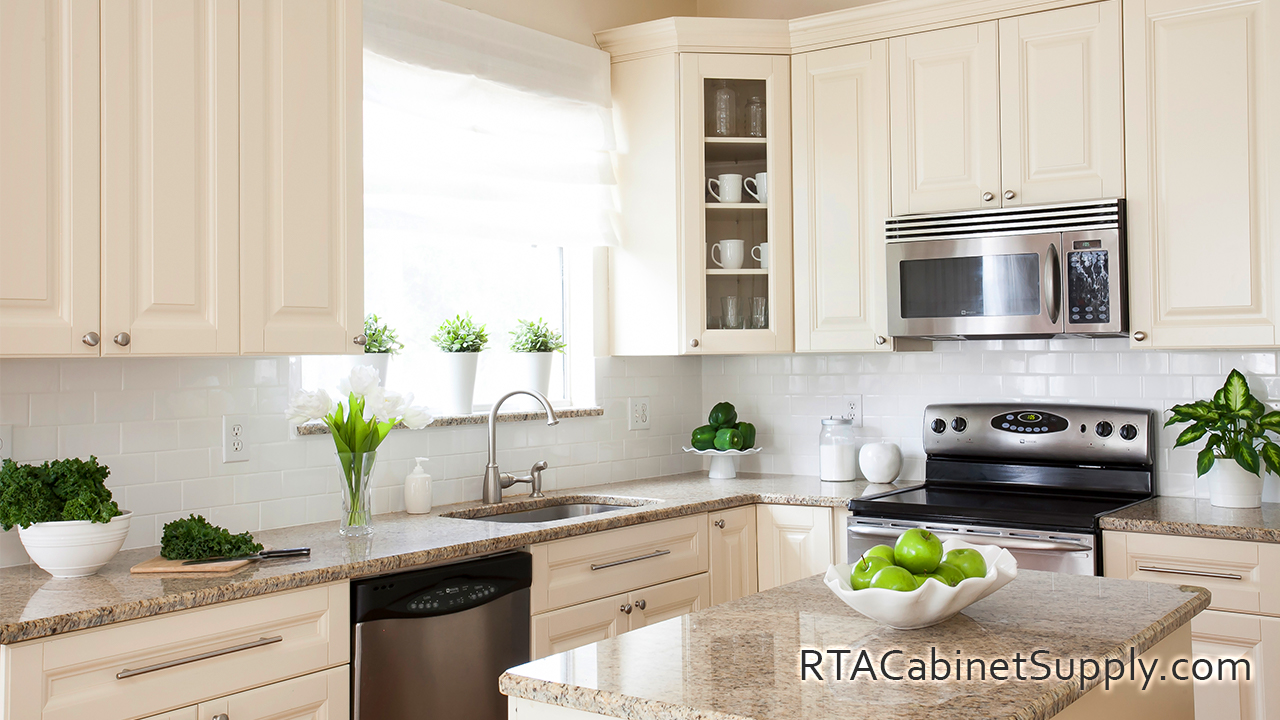 Holmdel Cream kitchen close up angle view with an island, a sink, a glass door cabinet, wall and base cabinets.