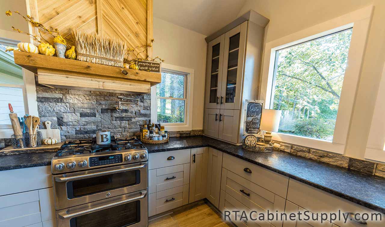 Anchester Grey kitchen angle view with an oven, a range hood and base cabinets.