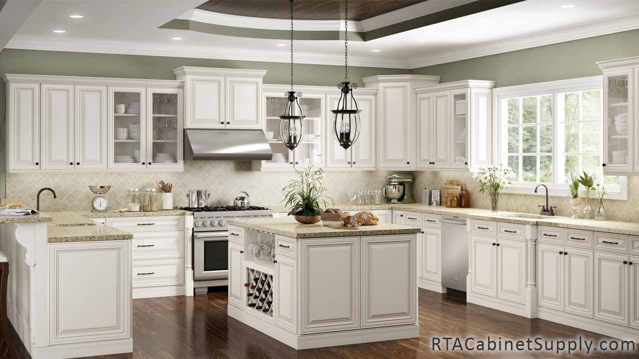 Charleston Cream kitchen full view with an island with a wine rack cabinet, wall and base cabinets, lighting and glass door cabinets.
