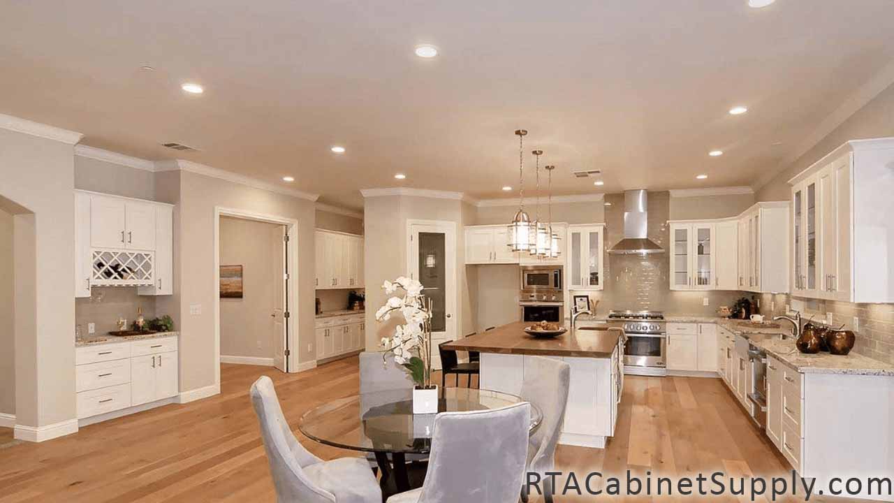 Classic White Shaker kitchen full angle view with a wine rack cabinet, a glass table, an island, wall and base cabinets, glass door cabinets.