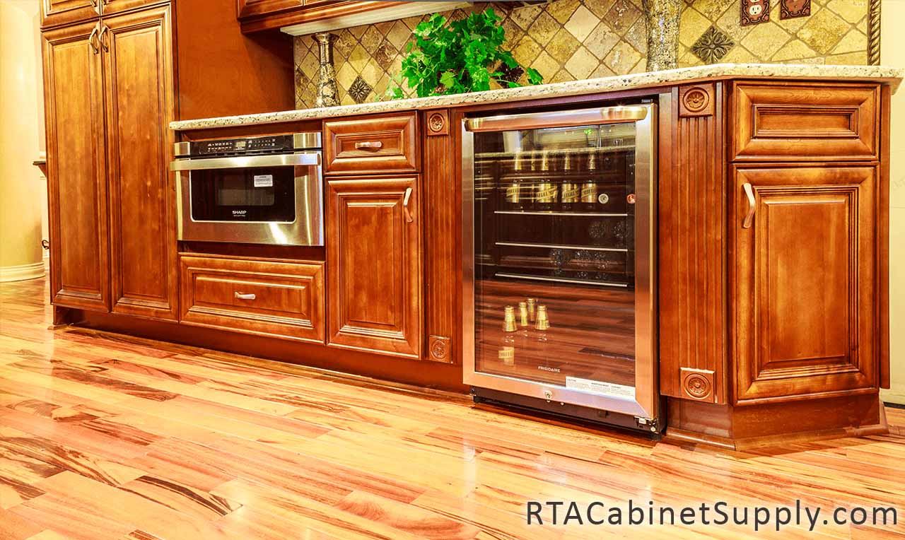 Coffee Cherry kitchen close up view with base cabinets, a pantry cabinet and a bar.