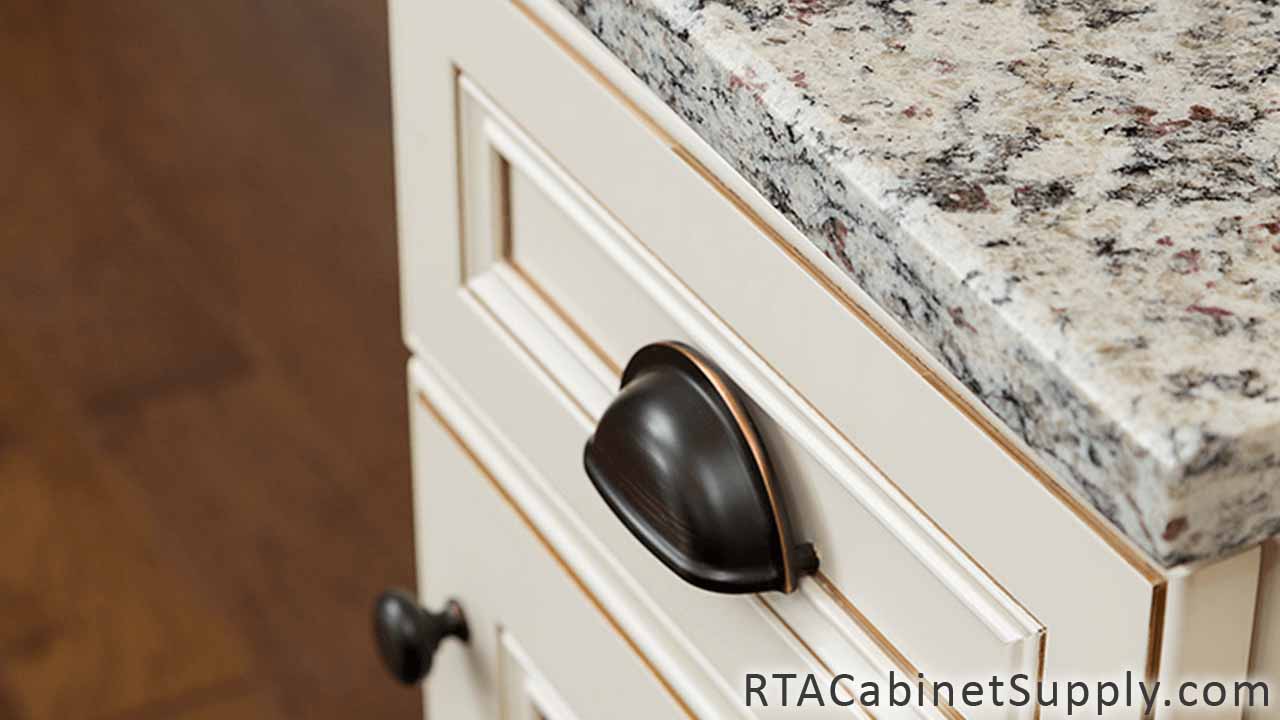 Antique White kitchen close up view with a base cabinet, knobs and handles.