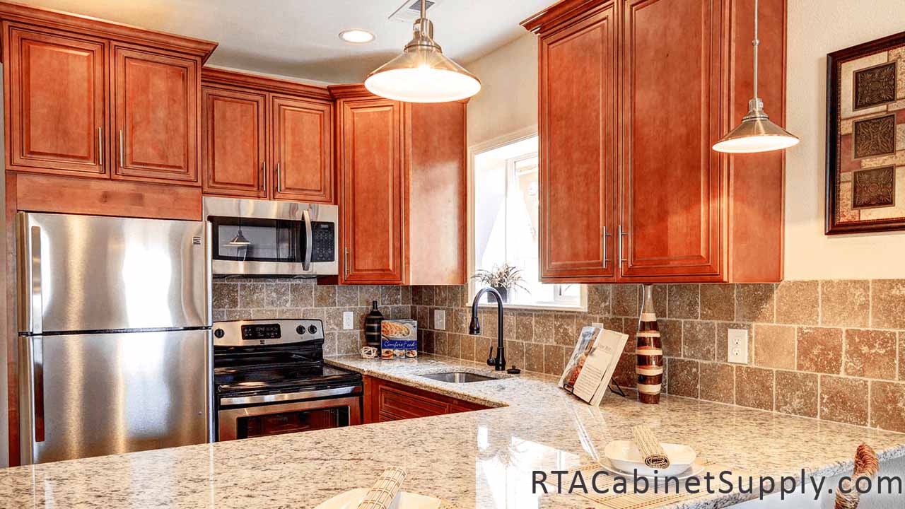 Coventry Toffee Glaze kitchen angle view with a countertop, lighting, wall and base cabinets.