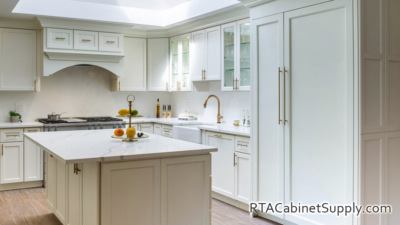 Hanover Dove kitchen angle view with an island, glass door cabinets, a pantry, a range hood cover, wall and base cabinets.