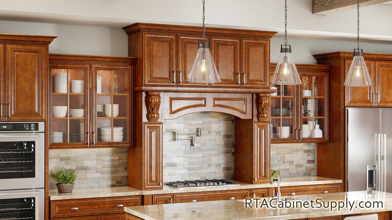 Hawick Chestnut Glaze kitchen close up view with a fridge, glass door cabinets, a countertop, an island, lighting, wall and base cabinets.
