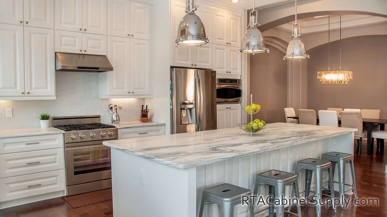 Essex White kitchen full angle view with lighting, an island, chairs, a fridge, wall and base cabinets.