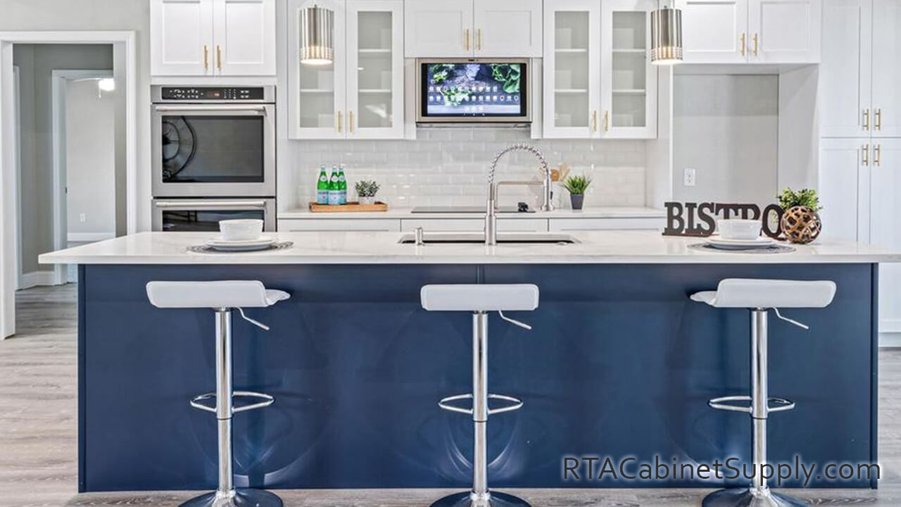 Madison White Shaker kitchen full view with an island, chairs, glass door cabinets, and wall cabinets.