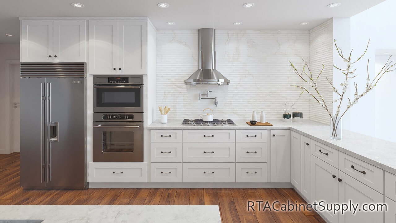 Madison White Shaker kitchen full view with a fridge, a range hood, a countertop, lighting, wall and base cabinets.