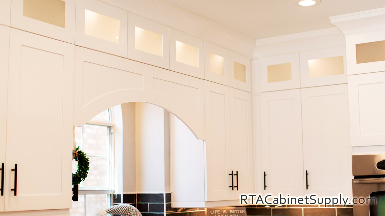 Madison White Shaker kitchen angle view with wall cabinets and glass door cabinets.
