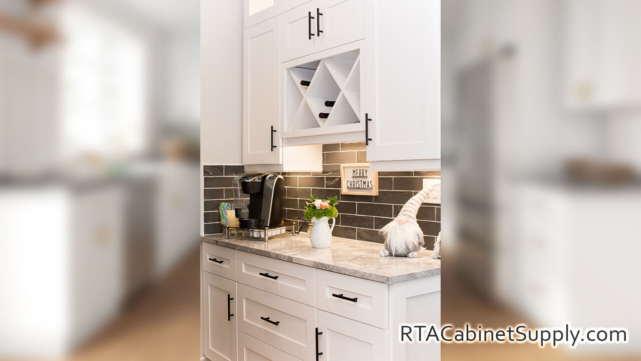 Madison White Shaker kitchen angle view with an island, a wine rack cabinet, wall and base cabinets.