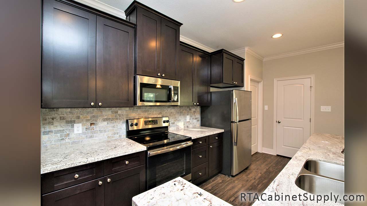 Newport Espresso Shaker kitchen angle view with a countertop, a fridge, lighting, wall and base cabinets.